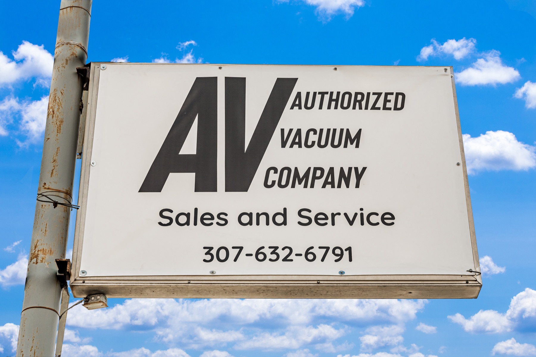 Authorized Vacuum Company pole sign, sales and service, 307-632-6791
